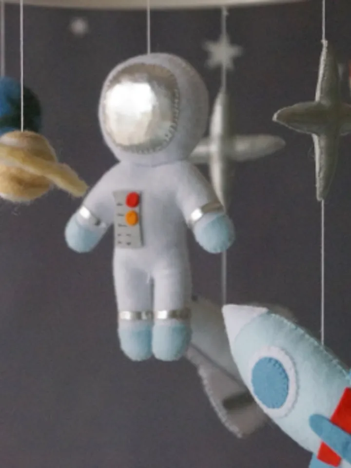 A space mobile for astronaut's nursery, a Shuttle and a rocket made of felt for the decor boy's room