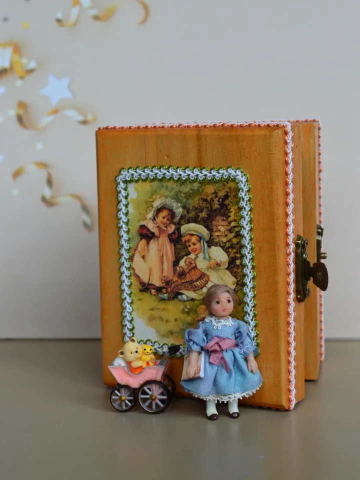 Miniature doll in 24th scale. Tiny doll with accessories in a wooden casket at a scale of 1:24.