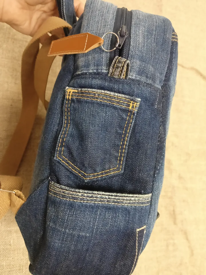 Casual unisex denim backpack made from eco-frendly recycled jeans, with 6 pockets outside and 2 pockets inside (1 with a zipper), strong belt on adjustable straps. Inside is colored cotton fabric. The back wall is quilted.
