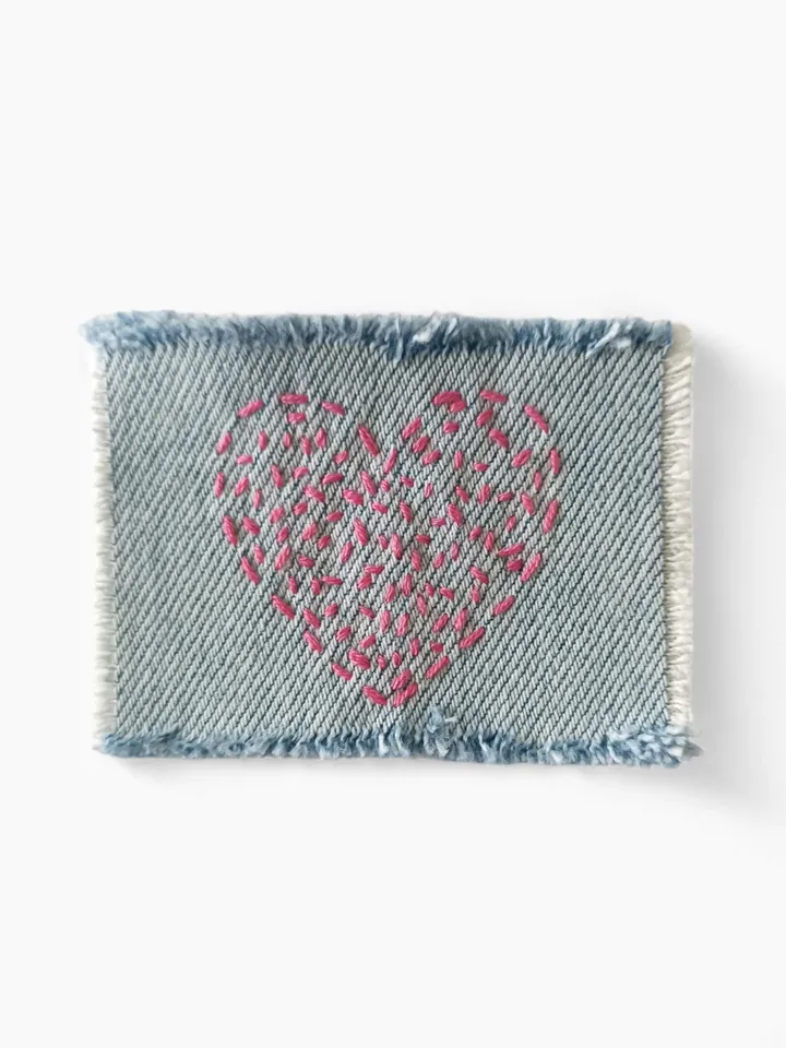 Denim patch hand sewn from recycled fabric.