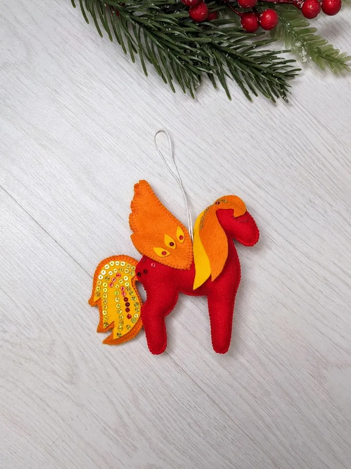 Pegasus in ancient Greek mythology is a winged horse, a favorite of the muses. Felt toy Red fiery Pegasus