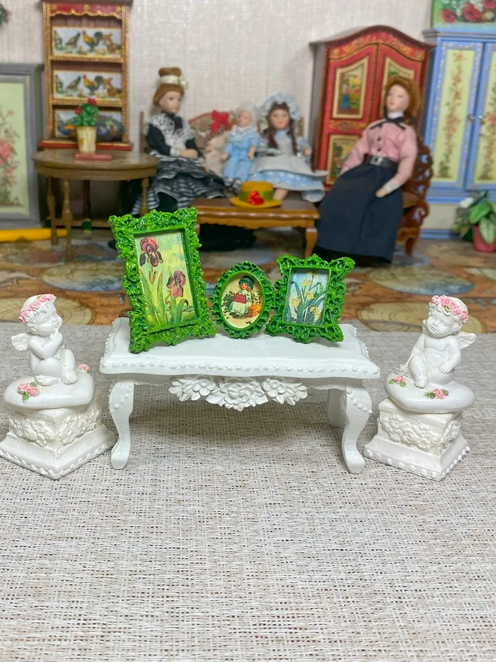 A set of frames with images of flowers. Dollhouse miniature. 1:12.