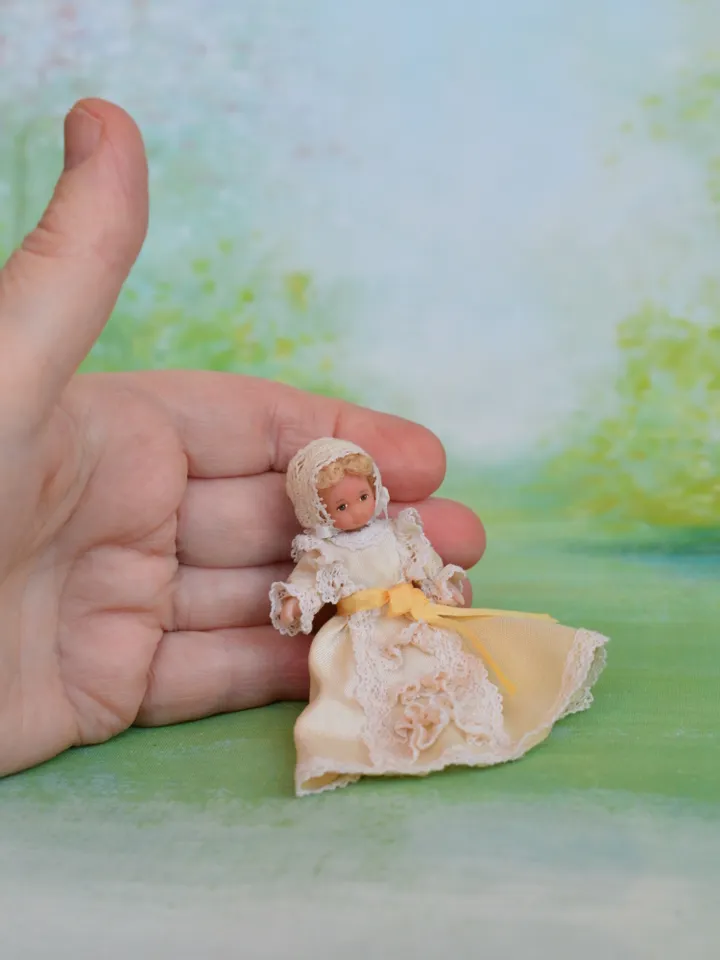 Miniature baby doll for Victorian dollhouse in 1/12 scale.