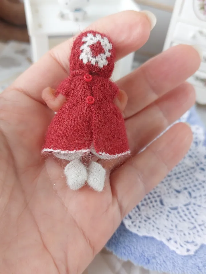 Miniature knitted red dress with white pants, socks and a hat for the silicone doll "My Mini Baby" by ZURU