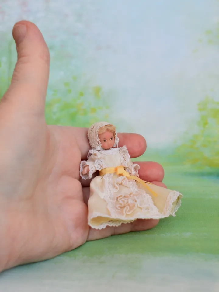 Miniature baby doll for Victorian dollhouse in 1/12 scale.