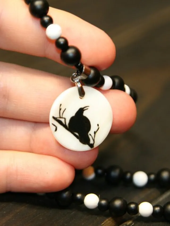 Raven or crow necklace with love rune on the other side. Nacre pearl pendant