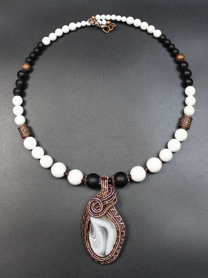 Handmade necklace with pendant made of stones and copper wire