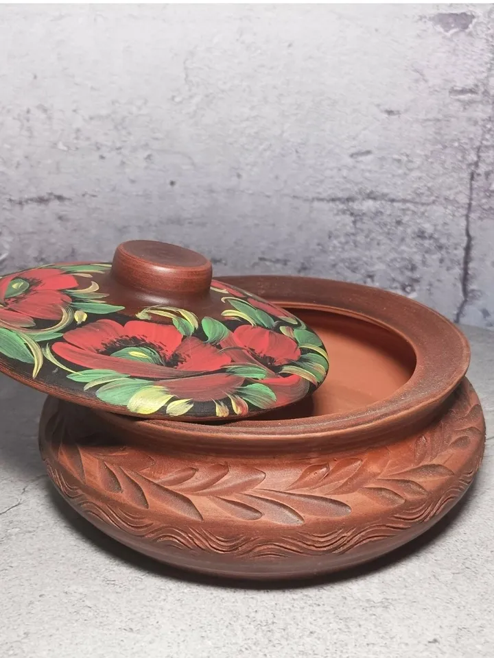 Ceramic casserole with a lid. Handmade from red clay. Carved pattern