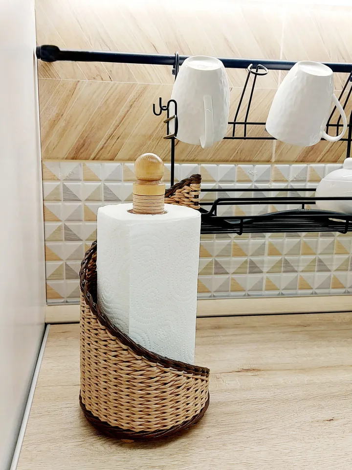 Beige paper towel holder with wooden tip. Wicker handmade holder.