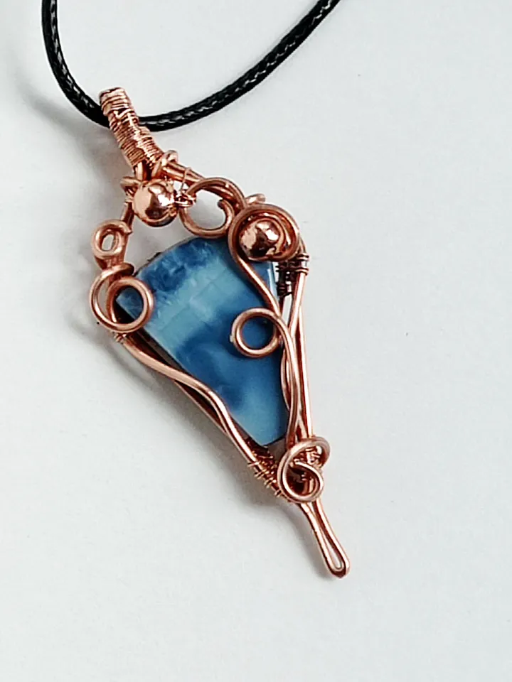 A necklace with a blue opal. Opal wire pendant as a gift.