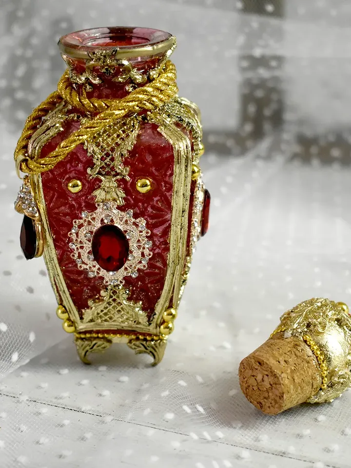 Red glass bottle for perfumes or aromatic oils dressing table decoration