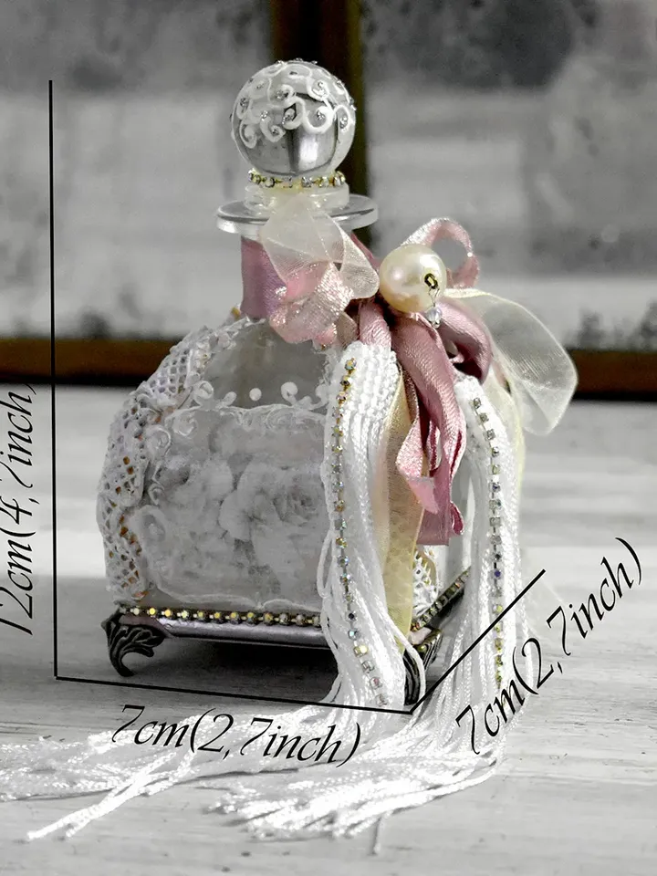 Rose glass bottle for storing perfumes and aroma oils with a voluminous decor