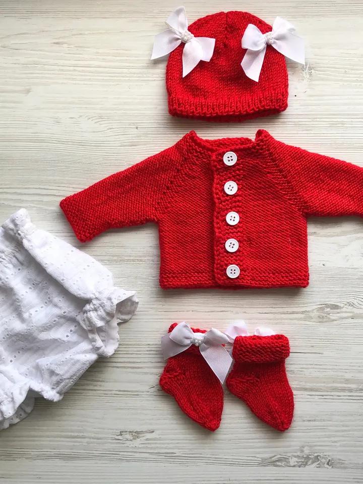 Knit red sweater with white lace, white lace panties, hat with bows and pearls, socks. Take home outfit for baby. Baby shower gift for girl