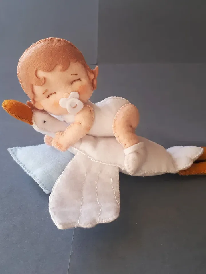 Baby doll and goose hugging sleep pillow for a fairytale nursery sewing pattern out of felt