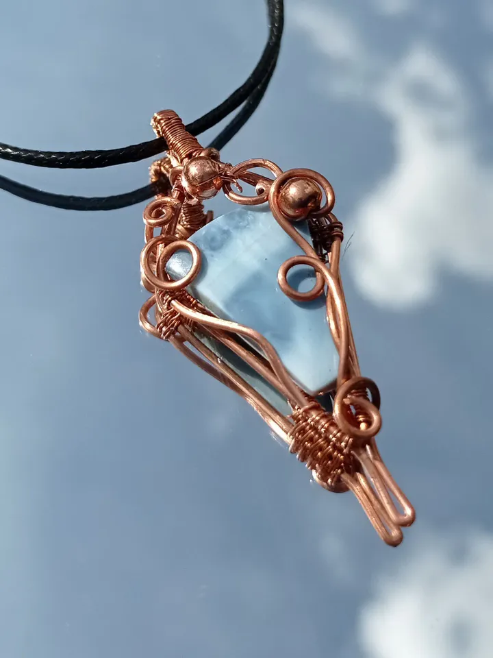 A necklace with a blue opal. Opal wire pendant as a gift.