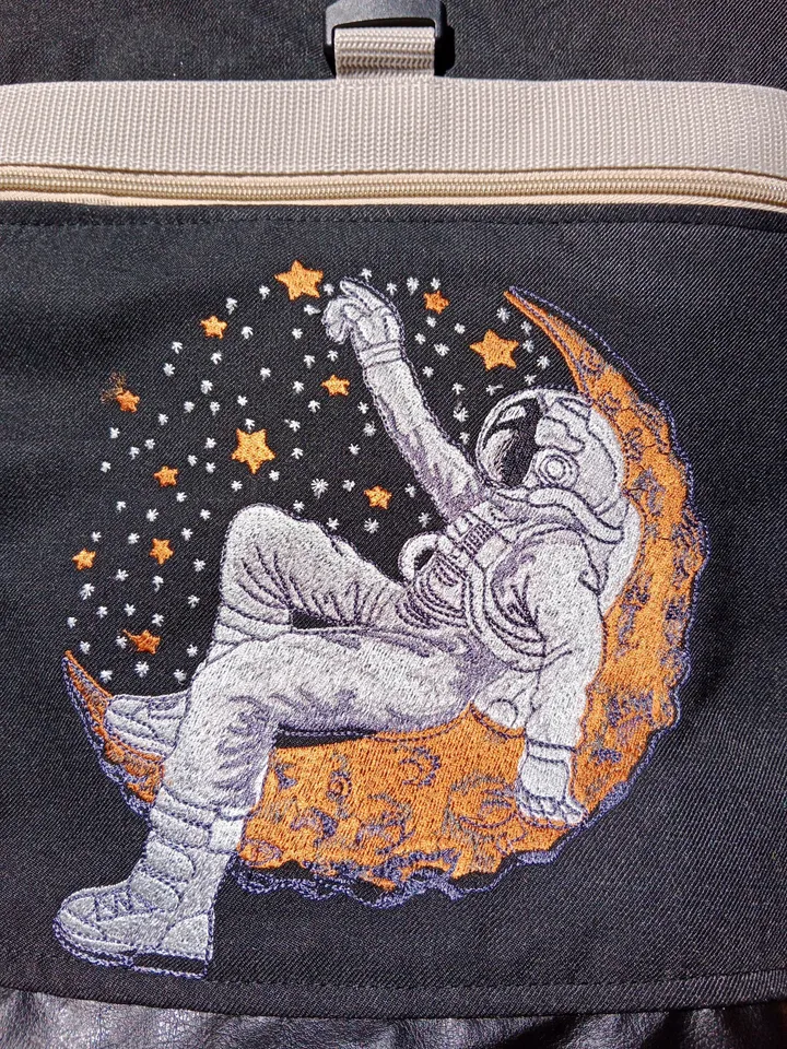 Roll top backpack with embroidery astronaut and stars