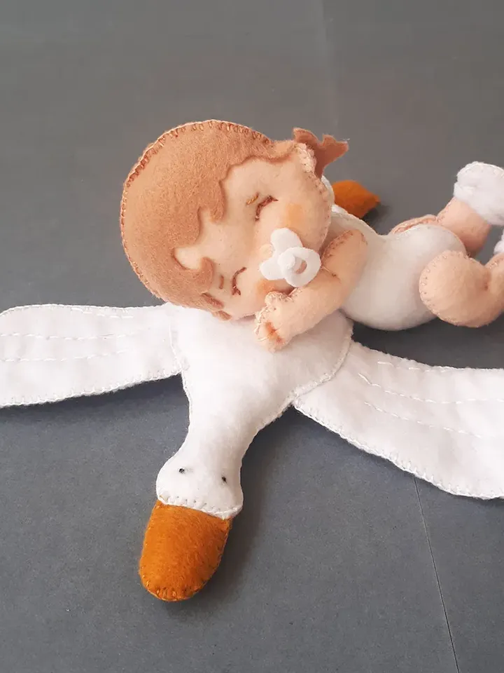 Baby doll and goose hugging sleep pillow for a fairytale nursery sewing pattern out of felt