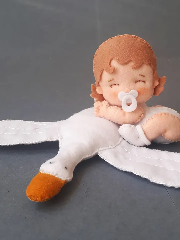 Baby doll and goose hugging sleep pillow for a fairytale nursery sewing pattern out of felt