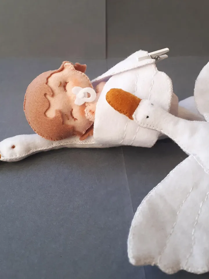Baby doll and goose hugging sleep pillow for a fairytale nursery sewing pattern out of felt