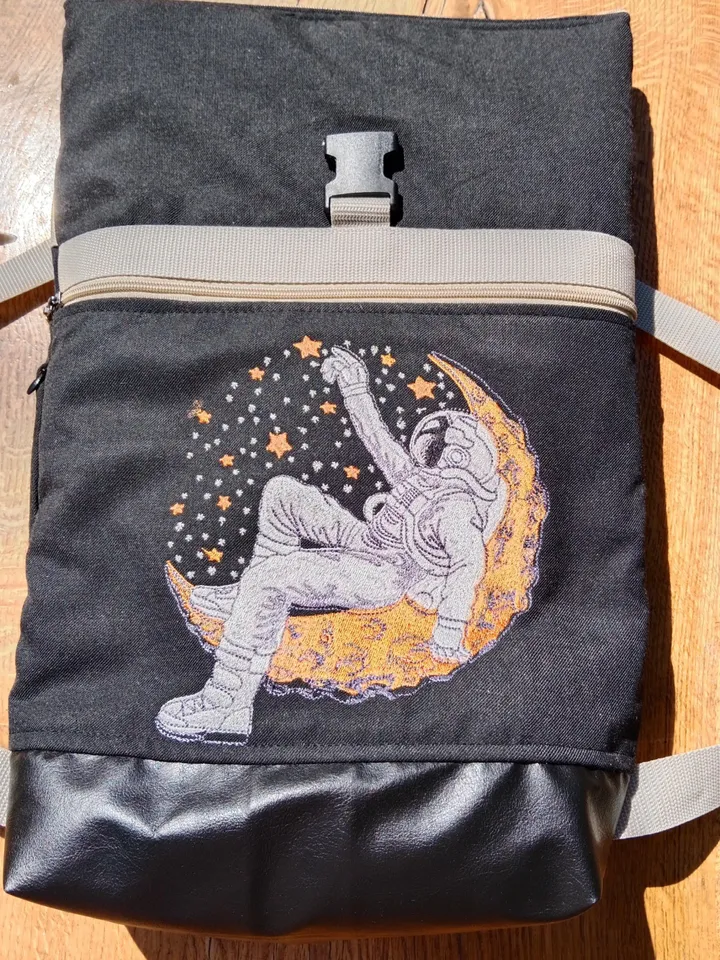 Roll top backpack with embroidery astronaut and stars