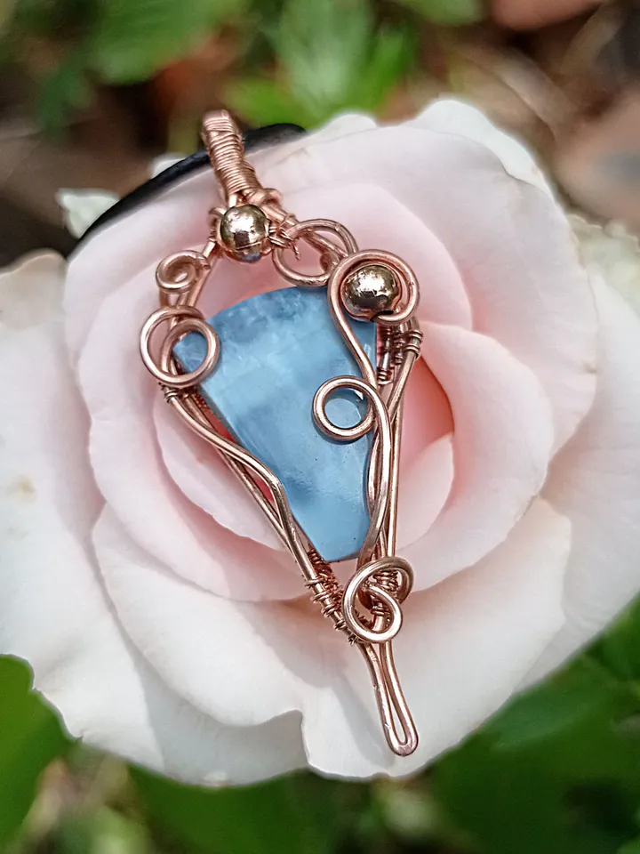 A necklace with a blue opal. Opal wire pendant as a gift.