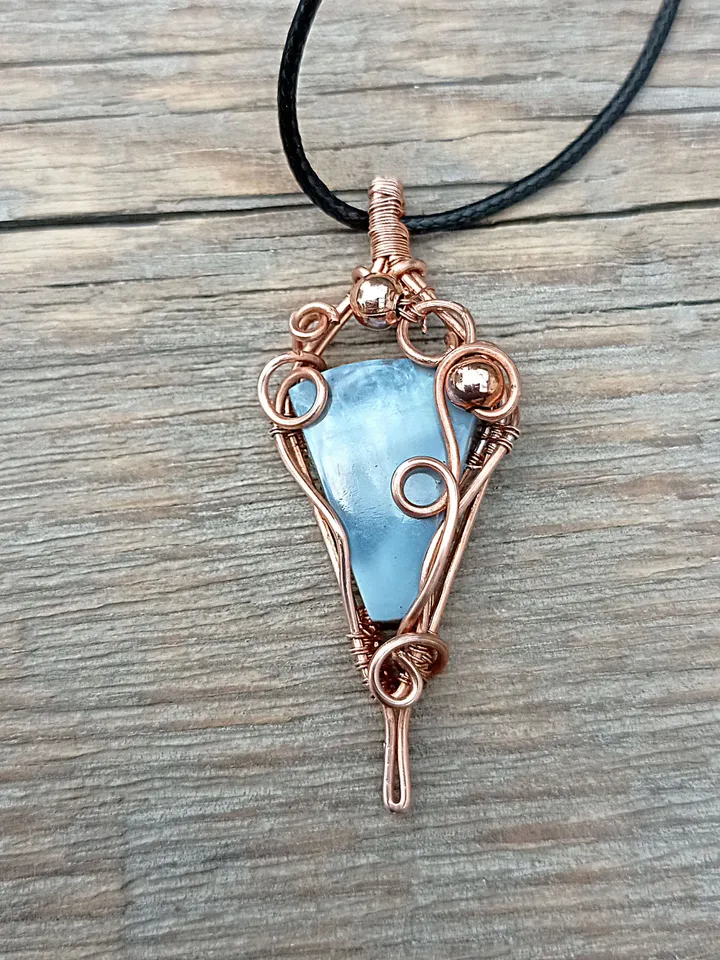 A necklace with a blue opal. Opal wire pendant as a gift.