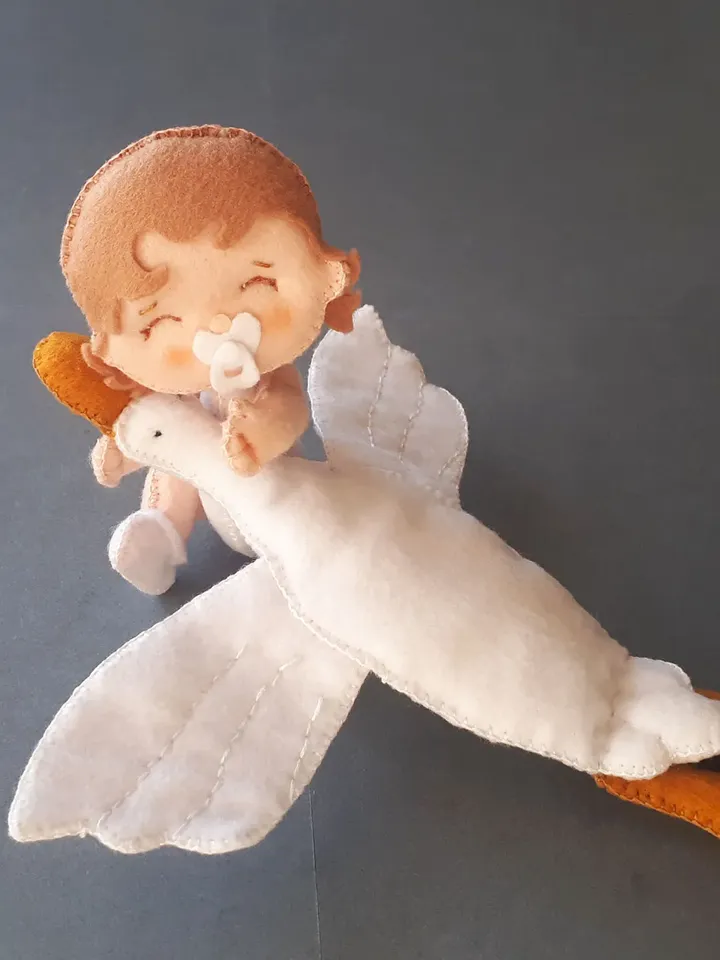 Baby doll and goose hugging sleep pillow for a fairytale nursery sewing pattern out of felt