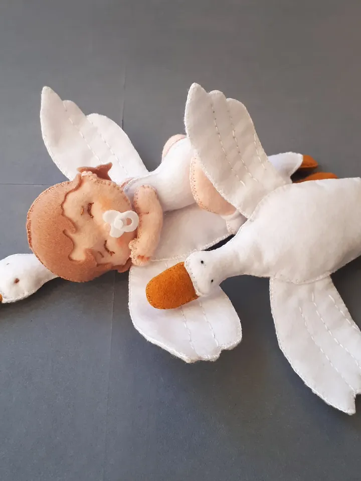 Baby doll and goose hugging sleep pillow for a fairytale nursery sewing pattern out of felt