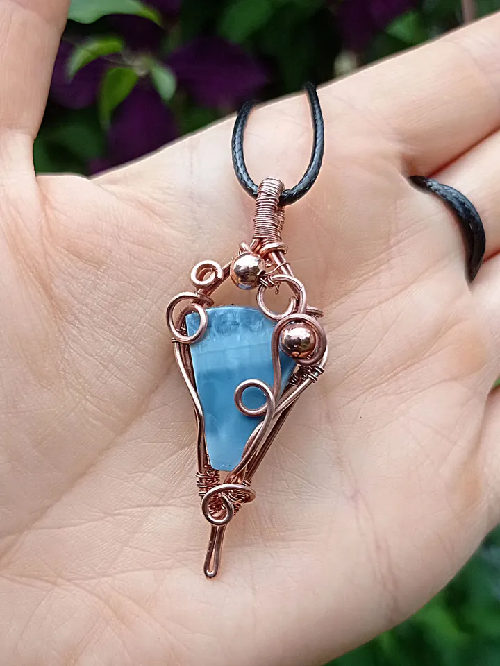A necklace with a blue opal. Opal wire pendant as a gift.