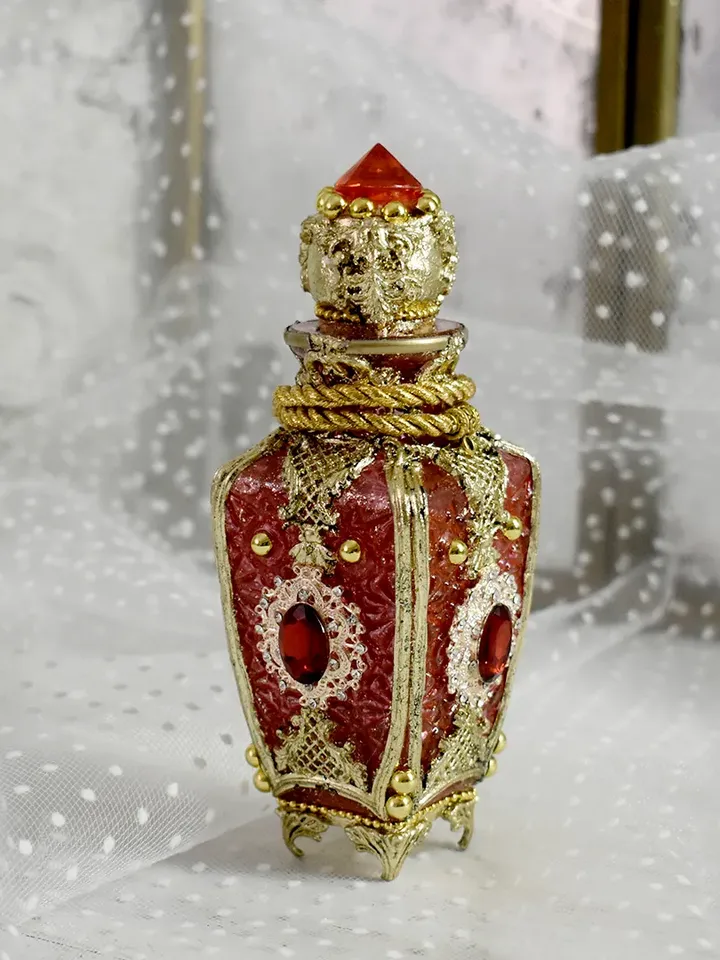 Red glass bottle for perfumes or aromatic oils dressing table decoration