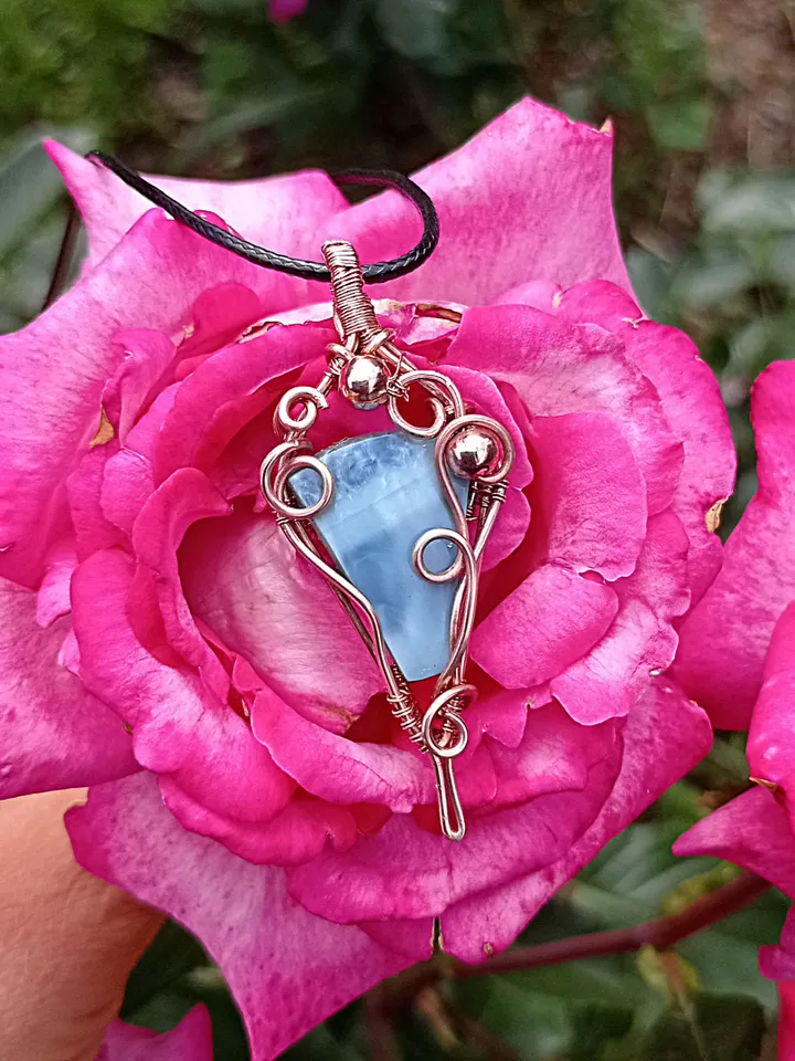 A necklace with a blue opal. Opal wire pendant as a gift.