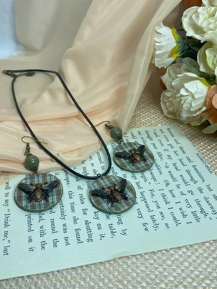 Author's set of handmade jewelry.Earrings and pendant on a cord with voluminous flies.