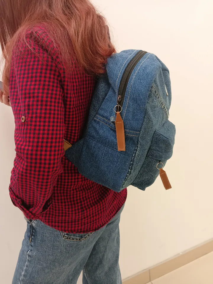 Everyday denim backpack made from recycled jeans, 3 pockets outside (1 volumetric with a zipper), 2 pockets inside (1 with a zipper) 100 percent cotton inside, strong handles made of cotton straps, leather strips on the zipper puller. decorated with a lab
