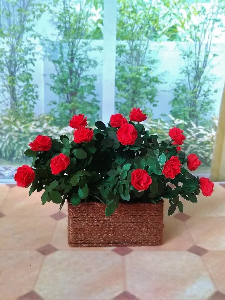 Miniature roses in a flowerpot. Dollhouse miniature.