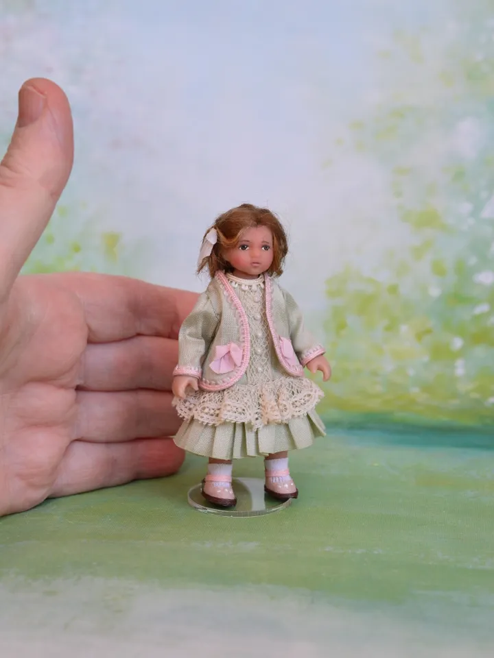 Miniature girl doll for Victorian dollhouse in 1/12 scale.