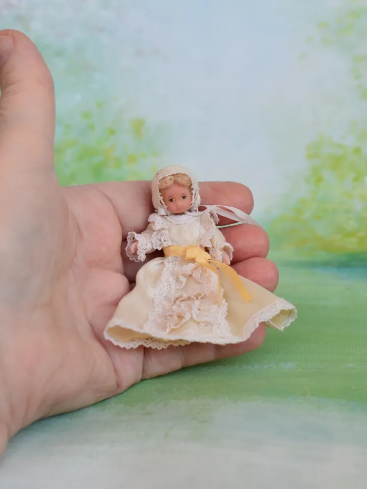 Miniature baby doll for Victorian dollhouse in 1/12 scale.