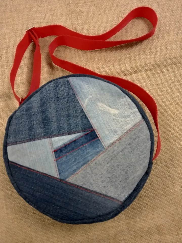 Cute handmade denim round crossbody bag with Red belt, brown polka dot cotton inside, pockets inside and outside, leather zipper stripe, weight only 160 grams, very light. A handbag for walks, excursions, and travel.