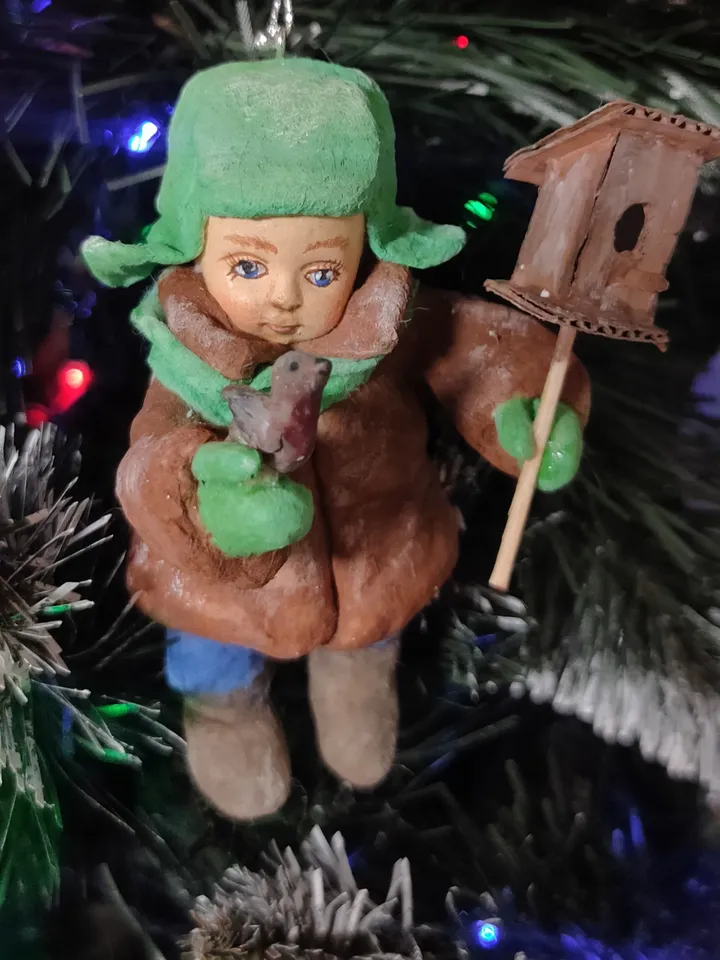 A boy with a birdhouse.