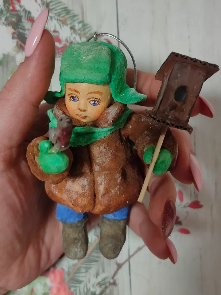 A boy with a birdhouse.