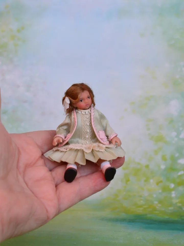 Miniature girl doll for Victorian dollhouse in 1/12 scale.