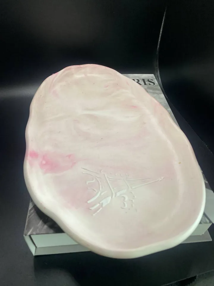 Handmade oval decorative tray made of plaster using marble pouring technique