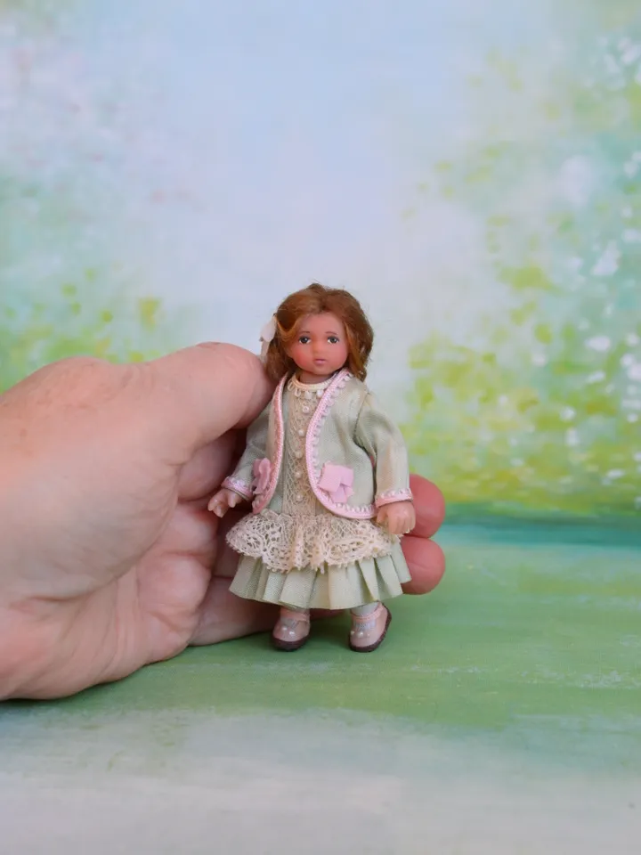 Miniature girl doll for Victorian dollhouse in 1/12 scale.