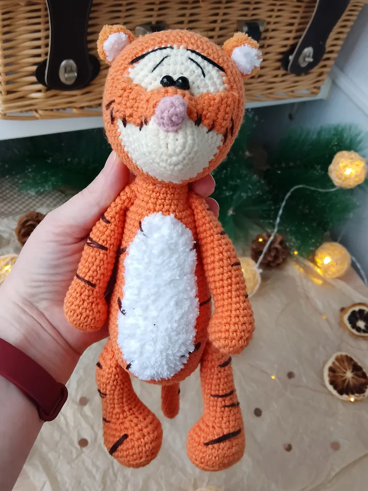 Orange tiger cub Disney cartoon character. Stuffed animal tiger soft toy
