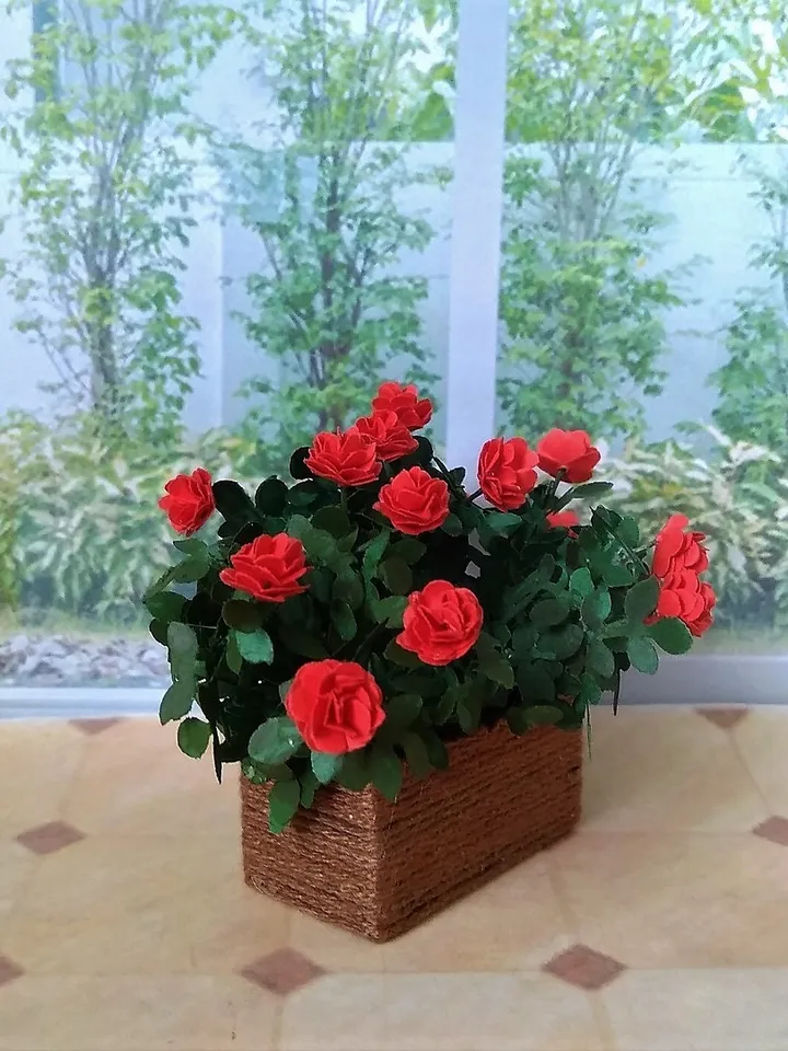 Miniature roses in a flowerpot. Dollhouse miniature.