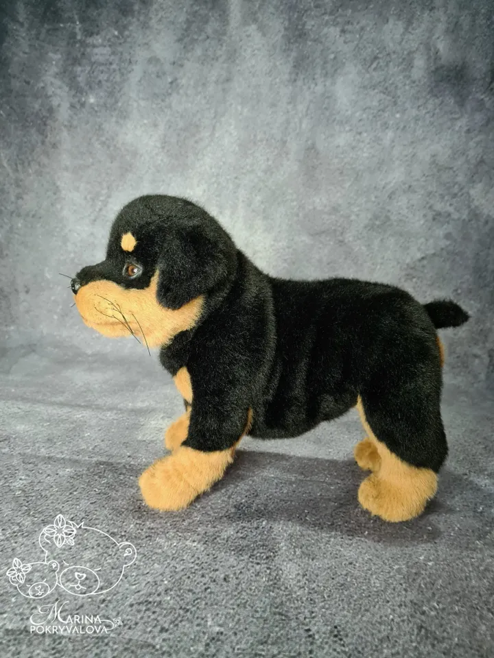 Rottweiler. Realistic dog. Lifelike toy dog. Stuffed dog.