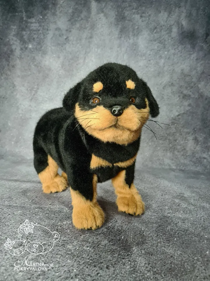 Rottweiler. Realistic dog. Lifelike toy dog. Stuffed dog.