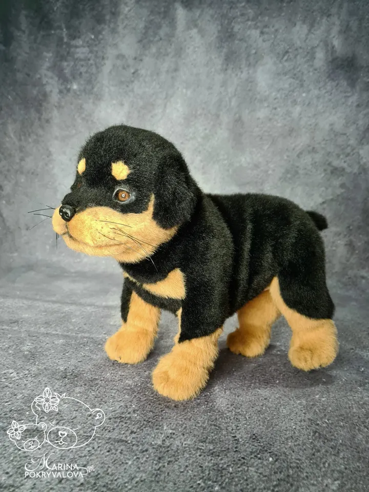 Rottweiler. Realistic dog. Lifelike toy dog. Stuffed dog.