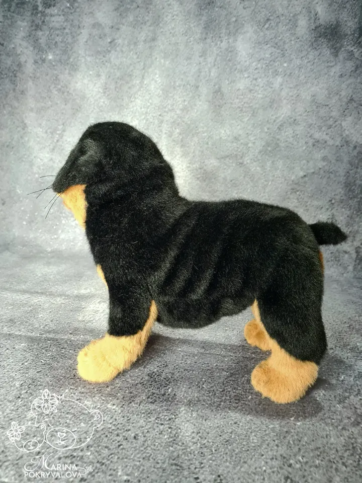 Rottweiler. Realistic dog. Lifelike toy dog. Stuffed dog.