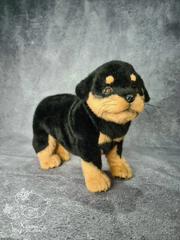Rottweiler. Realistic dog. Lifelike toy dog. Stuffed dog.