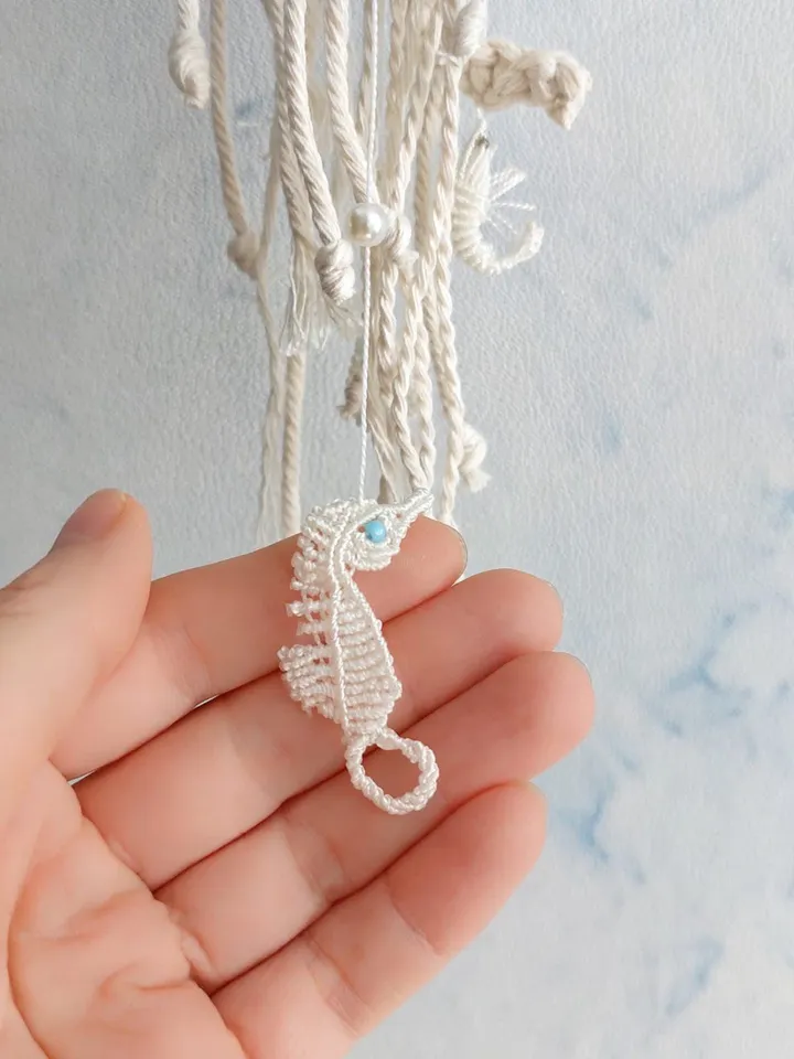 Pendant decoration in the shape of a jellyfish made of macramé. Modern macramé. Home decor in coastal style. crochet jellyfish
